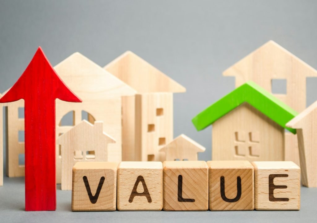 Wooden blocks with the word Value, up arrow and wooden houses